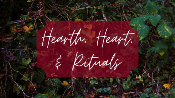 Text "Hearth, Heart, & Rituals" in white cursive is overlaid on a red banner, set against a background of lush, green foliage and vines.
